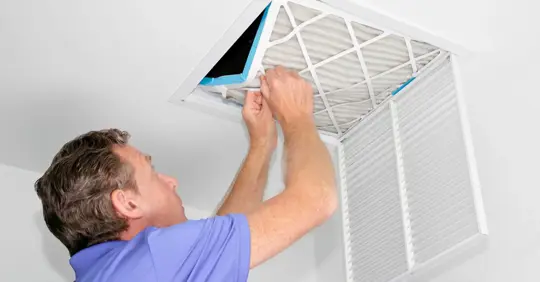 Man Removing Dirty Air Filter